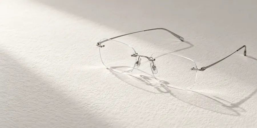 Randlose Titanbrille auf grobem Papier im Seitenlicht (Illustration)